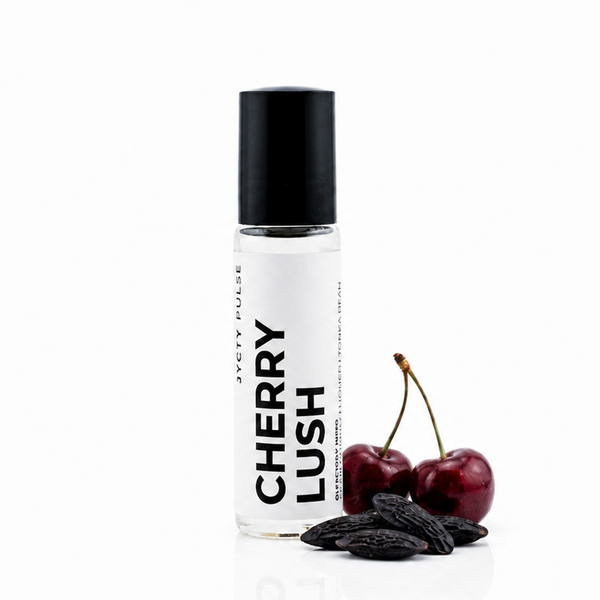 A Cherry Lush roll-on bottle by jyctys, shown with two fresh cherries and dark chocolate pieces on a clean white background.
