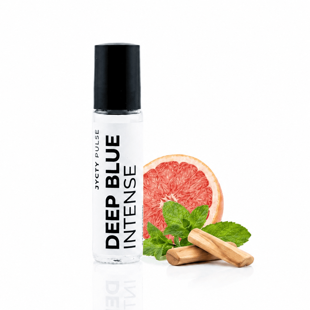 A clear roll-on bottle labeled 'JYCTY PULSE DEEP BLUE INTENSE' with a black cap, styled with a grapefruit slice, mint leaves, and cinnamon sticks on a white background.