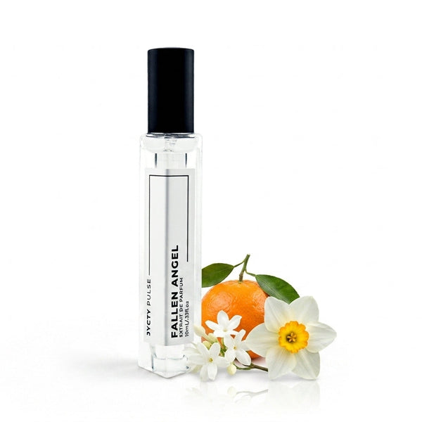 A clear glass perfume roller bottle with a black cap, labeled 'FALLEN ANGEL' and 'JYCTY PULSE', standing next to a small orange, white flowers, and green leaves on a white background.